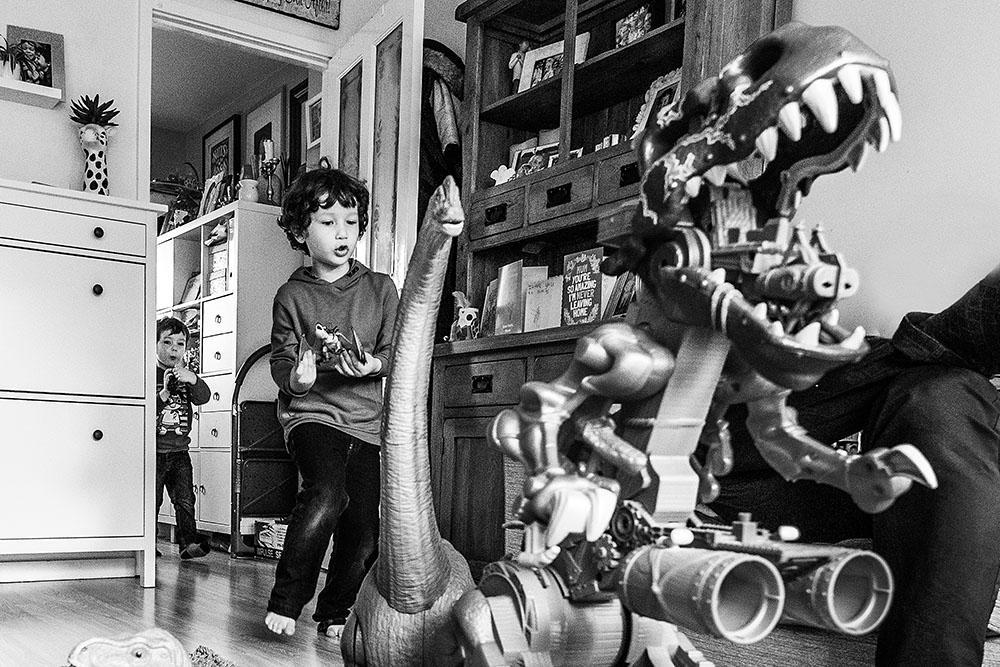 siblings playing with dinosaurs from family documentary photography session in London